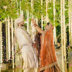 A candid and joyful varmala moment. We captured the bride playfully putting the garland on the groom amidst a shower of petals.