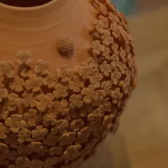 Here is the floral vase after its first firing, known as a bisque. The intricate details of the unglazed clay flowers are so beautiful on their own, it almost feels a shame to glaze it.