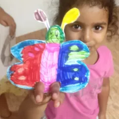 A close-up of a beautifully colored butterfly craft. This project is great for younger children to practice their coloring and assembly skills.