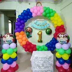 This is a Cocomelon theme I did for a first birthday party. It features a full circular balloon arch in rainbow colors, character cutouts, and matching balloon pillars, turning the living room into a fun, themed play area for the little one.