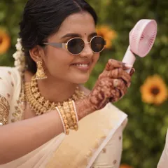 A fun, candid moment from a South Indian wedding. Even while keeping cool, her makeup remains flawless. This is the goal: beauty that is effortless and real.