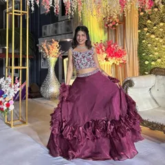 The full view of the maroon organza set shows the beautiful volume of the ruffled skirt. It's a lightweight yet impactful outfit for any celebration.