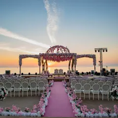 A breathtaking sunset mandap set against the serene expanse of the sea. We specialize in creating these once-in-a-lifetime destination wedding experiences, where every detail is designed to complement the natural beauty of the location.