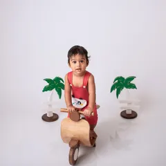 Let's go for a ride. This themed baby shoot uses a fun wooden scooter prop to create a playful and imaginative portrait.