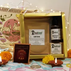 The complete Abhyanga Snan gift set, beautifully arranged with festive lights. It includes Ubtan, Abhyanga Tailam, and Kesar soap for a full-body ritual.