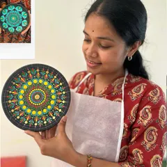 A participant admiring her incredibly detailed and colorful dot mandala plate. A true masterpiece.