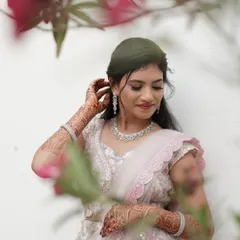 A full view of the soft and elegant reception look. The hairstyle and makeup work together to create a cohesive and romantic style, perfect for a modern bride.