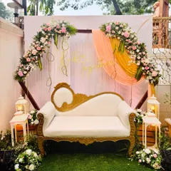 This classic photo booth setup is both elegant and romantic. It features a beautiful floral arch, soft drapes, and a "Better Together" neon sign. The vintage-style white and gold chaise lounge provides the perfect seating for picture-perfect moments.