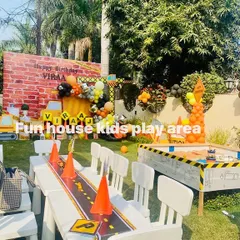 A full view of a construction-themed party, where we provided the themed sandpit and the white tables and chairs for the little guests.