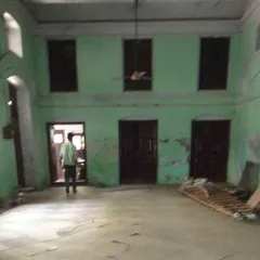 The same hall before our work began, with peeling paint and years of neglect hiding its incredible architectural potential.
