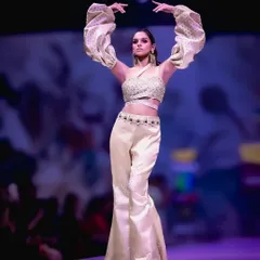 A powerful pose on the runway. The unique puffed sleeves and flared pants create a striking silhouette, and my focus was to freeze that dynamic movement, showcasing the designer's creative vision.
