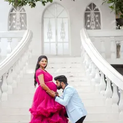 A fairytale moment for the parents-to-be. This shot, taken on a grand white staircase, combines a beautiful flowing gown and a tender pose to create a dramatic and romantic pregnancy portrait.