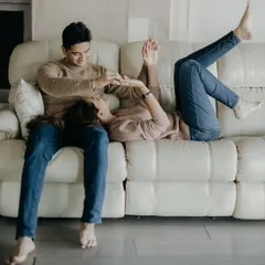 A playful, carefree moment on the couch. My goal is to make you feel so comfortable that you forget the camera is there, allowing your true personalities to shine.