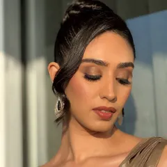This shot showcases the elegant updo and the soft, blended makeup from a different angle. The focus is on creating a look that is both bold and effortlessly chic.