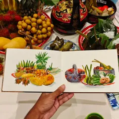 Sketching food is like tasting it twice. Here’s a spread of delicious Thai food I got to illustrate before I got to eat it. My sketchbook shows the vibrant colors of the fruits and local dishes, with the real feast right behind it, ready to be enjoyed.