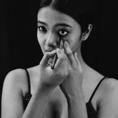 A tighter shot of the actor's ritual. The intensity in her eyes shows the mental preparation that goes into a performance, whether on stage or for the camera.