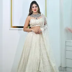 This ivory and gold sequin lehenga is pure elegance. It's a lightweight yet glamorous option for a reception or sangeet, paired here with a statement diamond necklace.