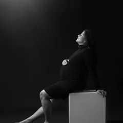A simple, elegant, and classic maternity portrait. Using dramatic lighting in the studio, I focused on creating a serene and contemplative mood, highlighting the beautiful silhouette of the mother-to-be against a dark backdrop.