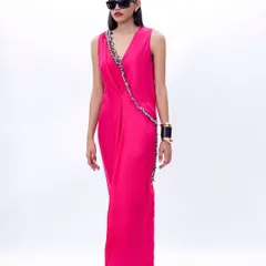 The full view of the fuchsia draped dress, showcasing its asymmetrical hem and modern, fluid design.