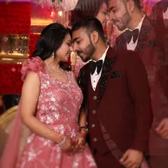 A romantic close-up of a couple during their engagement party, capturing an intimate moment against a backdrop of red roses.