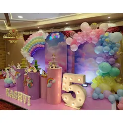 Another angle of the unicorn party, showcasing the flying unicorn prop and rainbow details on the plinths.