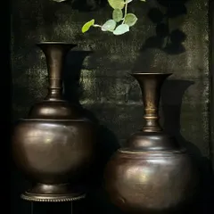 A pair of large copper vases with a beautiful vintage finish. Their exquisite shape and form make them perfect for an entryway or on end tables, either together or on opposite sides for symmetry.