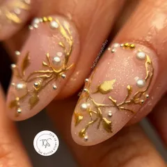 Another angle showing the intricate detail of the 3D gold and pearl nail art. You can see how the elements are layered to create depth and texture, perfect for wedding photography.