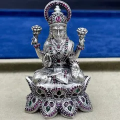 A close-up of our Goddess Lakshmi idol, seated on a lotus. Notice the detailed craftsmanship in her adornments and the clarity of the ruby and emerald stones, all set in 925 sterling silver.