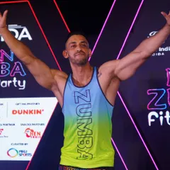 A moment of pure joy and accomplishment on stage after a massive Zumba party. This is the feeling we all share after giving it our all on the dance floor. The professional stage and lighting add to the festival atmosphere.
