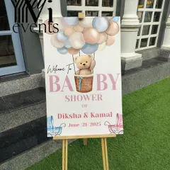 A personalized welcome easel sign for a baby shower, featuring a cute teddy bear and hot air balloon design.
