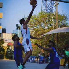 Executing a layup in traffic during the KBG Cup 2024. I teach players how to maintain control and finish strong against defenders.