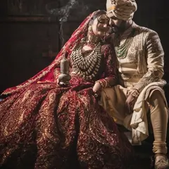 I believe in creating moments that feel like a scene from a classic film. This dramatic, moody shot captures the deep connection between the couple, with their coordinated regal attire telling a story of timeless love and opulence.