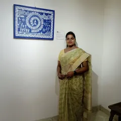Here I am with my sold Warli painting. This tribal art form uses simple geometric shapes to depict scenes of community life, like the circular dance shown here.