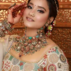 For a multi-colored lehenga, I opted for a soft, neutral makeup look with a touch of shimmer on the eyes. This ensures the makeup enhances her features without clashing with the vibrant outfit.