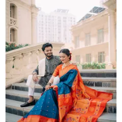 A quiet moment of togetherness on the steps of a grand location. I focus on capturing the natural chemistry between a couple, like the shared glance between Raj and Isha in their beautiful traditional Maharashtrian attire. This is a classic couple portrait that feels both royal and real.