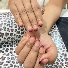 A darker, more dramatic take on the ombre trend. This design uses a deep burgundy color that fades from the tips into a natural nude base on rounded nails, creating a chic and moody effect.
