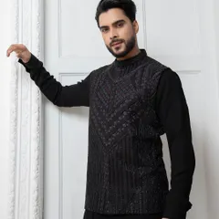A closer look at the embellished black jacket. The intricate cutdana embroidery creates a subtle texture that catches the light, perfect for an evening event.
