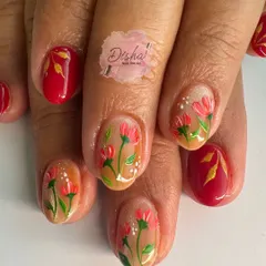 Beautiful hand-painted floral nails for the festive season. This design features delicate red flowers on a neutral base, accented with solid red nails and gold leaf details.