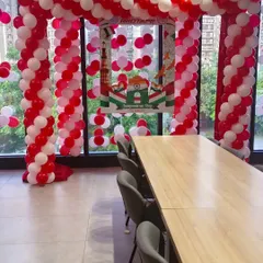 This is an example of office party decoration I did for RedTape. I set up a balloon arch in the company's colors and created a custom branded selfie frame for their Independence Day celebration.