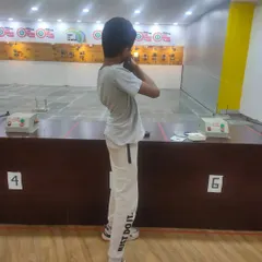 A young shooter learning the correct standing posture. Our basic courses cover all the fundamentals, from safety rules to proper shooting techniques.