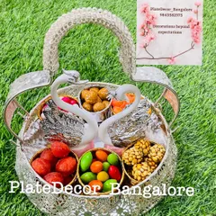 A beautiful swan-themed basket filled with various traditional Indian sweets (laddoos) and candies. A perfect gift for any celebration.