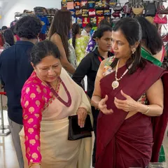 Interacting with a customer at my stall in Suryavanshi Hall, Dadar. I love helping clients find the perfect piece.