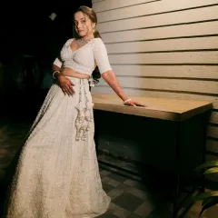 An ethereal all-white lehenga look, perfect for a reception or engagement. The makeup is kept soft and luminous to complement the intricate chikankari work.