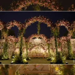 An enchanting Nikaah setup with intertwined floral arches against a hand-painted tropical backdrop. The central chandelier adds a touch of classic elegance to the natural, garden-like setting.