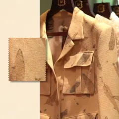 Texture that tells a story. This image pairs a jacket with a subtle leaf-print texture with a close-up swatch, highlighting details designed to elevate your style.