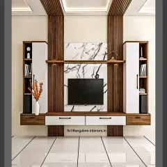 A symmetrical TV unit design featuring a central marble-finish panel flanked by tall storage cabinets. The combination of dark wood fluting and clean white surfaces creates a bold, contemporary statement.