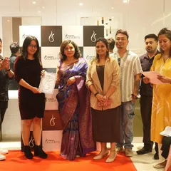 A student receives her certificate on stage during our academy launch event. We celebrate every milestone on your journey to becoming a beauty professional.