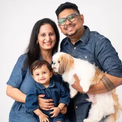 A little kiss from the family dog. These spontaneous moments of affection between kids, pets, and parents are what make these sessions so memorable.