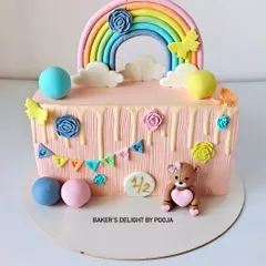 Half the age, double the cuteness! This half-birthday cake is a rectangular design with a pastel rainbow, a sweet fondant teddy bear, and colorful bunting to celebrate the six-month milestone.