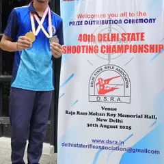 A young shooter showing off his gold and silver medals from the Delhi State Championship. The future is bright.